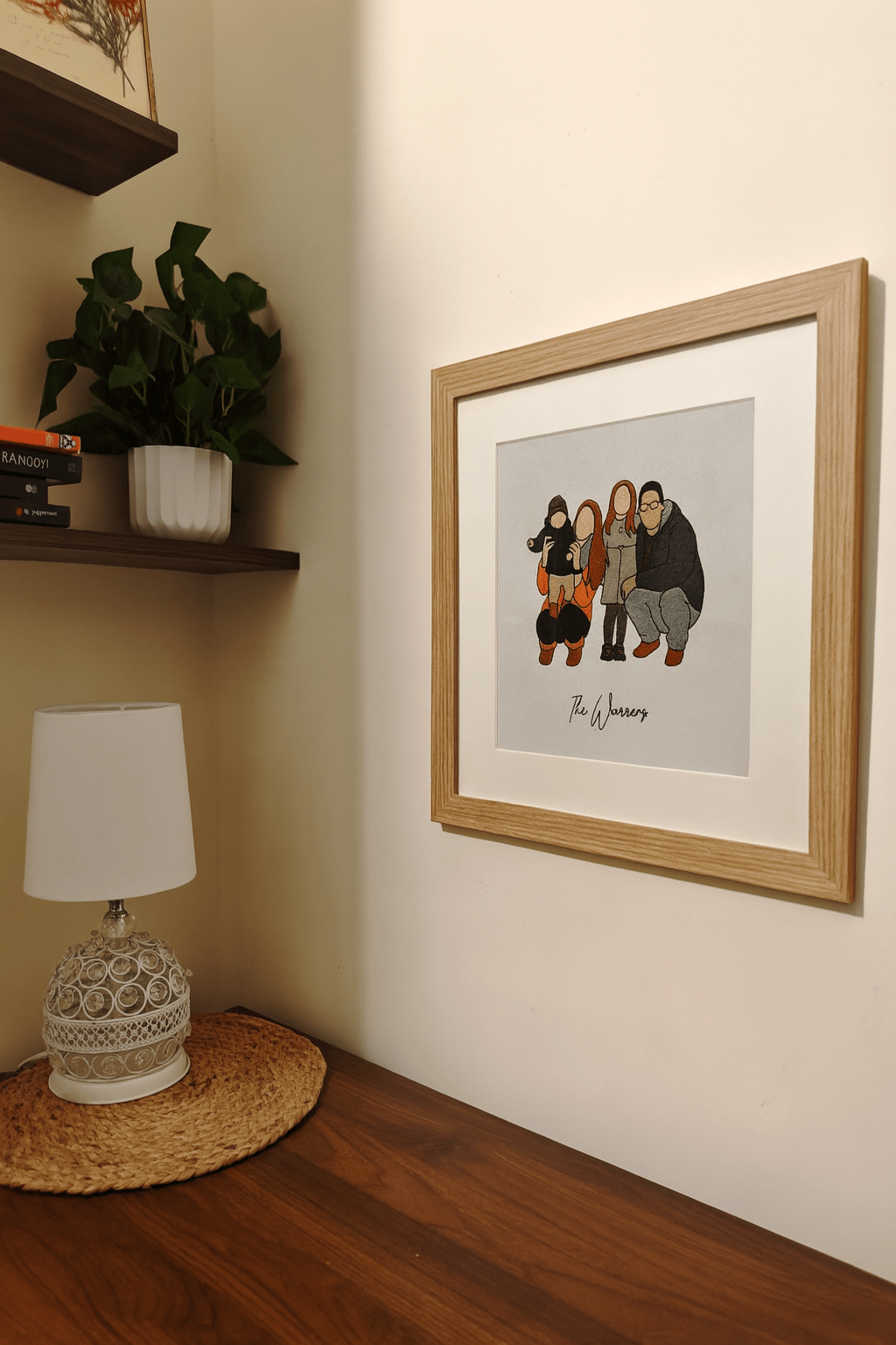 Custom embroidered family portrait in frame